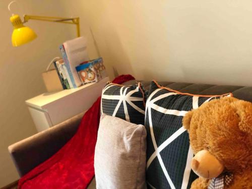 a teddy bear sitting on a couch with pillows at Connemara. 3 Bedroom, 8 bed, Holiday home in Galway