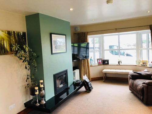a living room with a couch and a flat screen tv at Connemara. 3 Bedroom, 8 bed, Holiday home in Galway