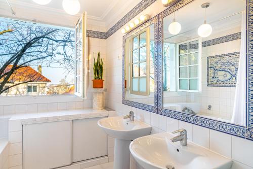 a bathroom with two sinks and a mirror at Double Appartements 210 sqm up to 18 guests, Villa des Ammonites 2&3 in Meudon