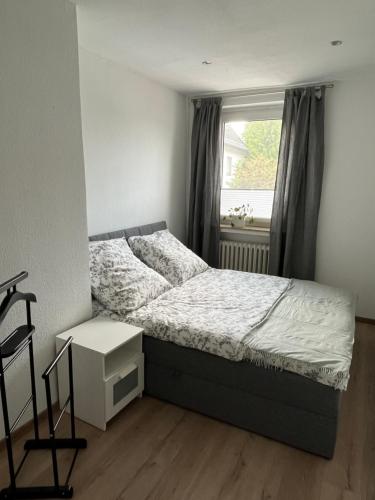 a bedroom with a bed and a window at 2 P. Appartement am Kurpark in Bad Driburg
