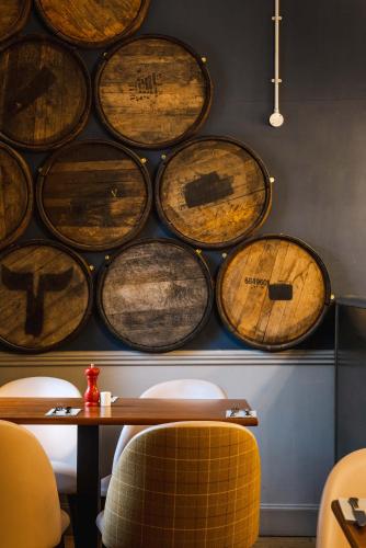 a bunch of wooden barrels on the wall of a restaurant at Traquair Arms Hotel in Innerleithen