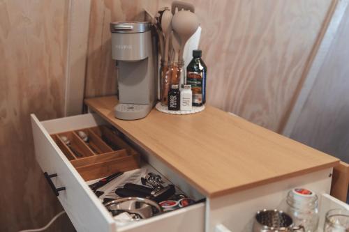 a cupboard with a coffee maker on top of it at Blue Brambler Glamping A-Frame in Rockbridge