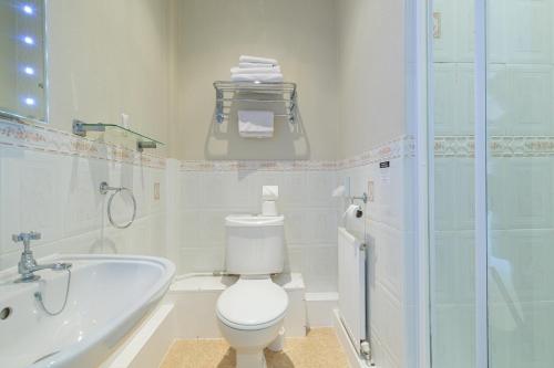 a bathroom with a toilet and a sink and a tub at Blacksmiths Arms Inn in Scarborough