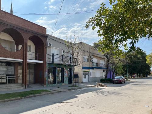 an empty street in a town with buildings at Departamentos Plaza Santo Tomé, Santa Fe in Santo Tomé