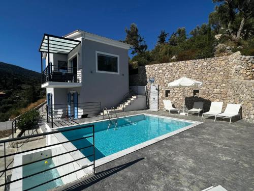a villa with a swimming pool and a house at Katerinas Village Supreme Villas with private pool in Agios Nikitas