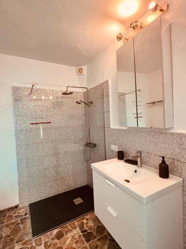 a bathroom with a white sink and a shower at Casa Turquesa en Tazacorte in Tazacorte