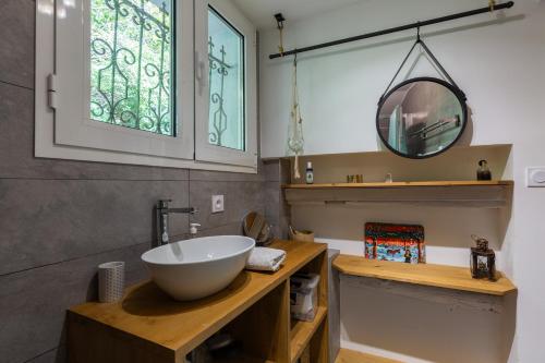 a bathroom with a bowl sink and a mirror at Quiet and Authentic Mountain Chalet in Saint Pierre en Faucigny
