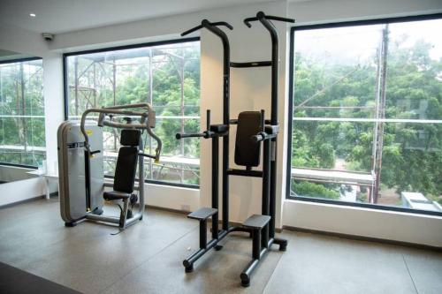 a gym with two tread machines and a large window at Plush Studio @Embassy Gardens in Cantonments