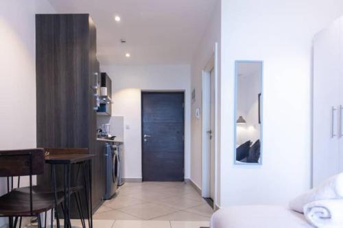 a living room with a kitchen and a dining room at Plush Studio @Embassy Gardens in Cantonments