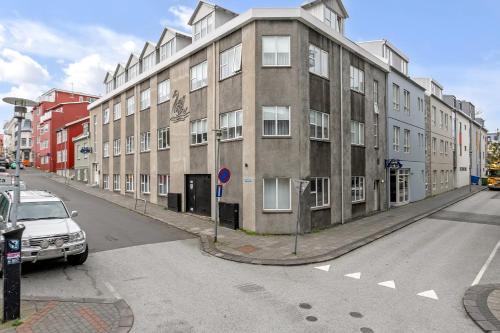 a building on a street with a car parked in front at The Swan House by Heimaleiga in Reykjavík