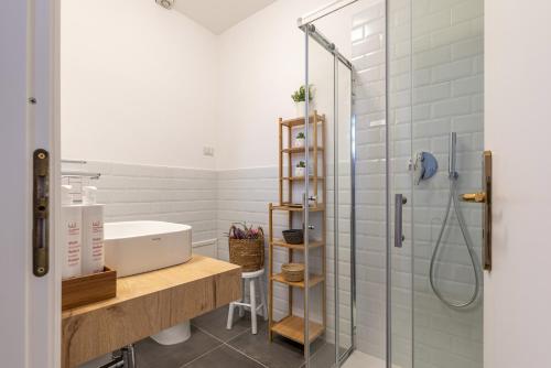 a bathroom with a shower and a sink and a tub at Cathedral View Loft by Wonderful Italy in Palermo
