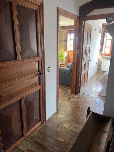 a room with a wooden door and a living room at Casa Rural Basiver - Habitación Pico Samelar in Armaño