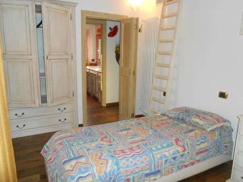 a bedroom with a bed with a colorful comforter at Agriturismo Circugnano in Grassina
