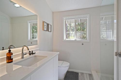 a white bathroom with a sink and a toilet at 1 Sunrise in Sunriver
