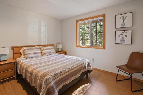 a bedroom with a bed and a window and a chair at 1 Sunrise in Sunriver