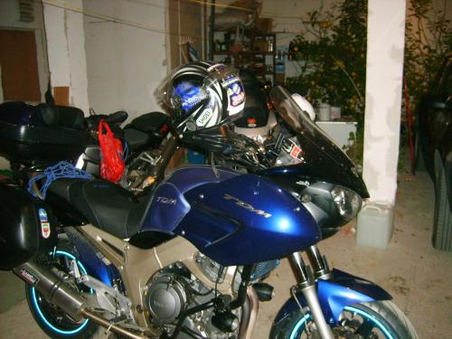 a blue motorcycle parked in a garage at Smeštaj - sobe MARVEL in Niš