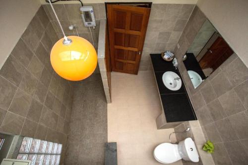 an overhead view of a bathroom with a yellow light at Be Fine Sabuy Hotel and Resort in Suratthani