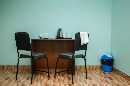 two chairs sitting next to a table in a room at Yaksa Hotel Pvt. Ltd. in Kathmandu