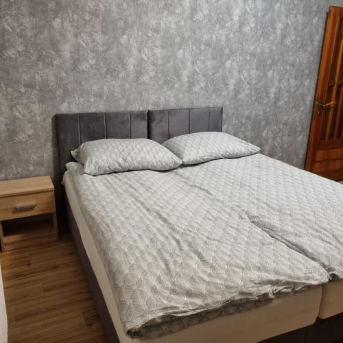 a bed with two pillows on it in a bedroom at WILLA MIŁA in Stalowa Wola