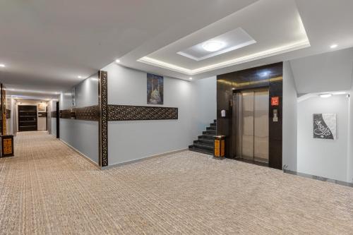 a hallway of a building with a staircase and a stair case at Luma Serviced Apartments in Al Madinah