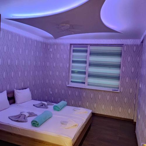 a bedroom with a bed with a purple ceiling at DB Luxury Apartment in Veliko Tŭrnovo