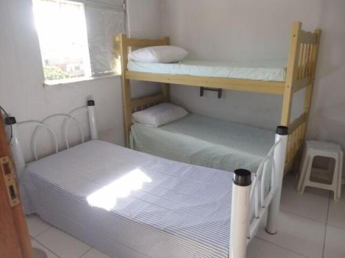 a small room with two bunk beds and a window at hostel barra in Salvador