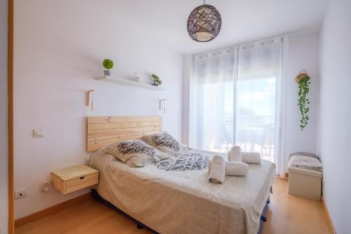 a bedroom with a bed and a large window at Casa Gemma in Alcanar