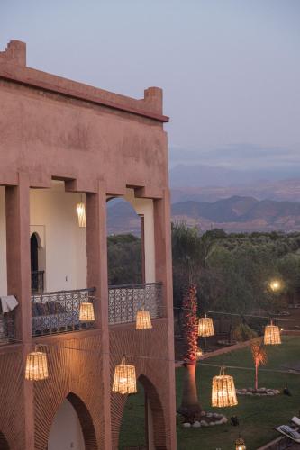 a building with lights on the side of it at Kasbah Caracalla in Aghmat