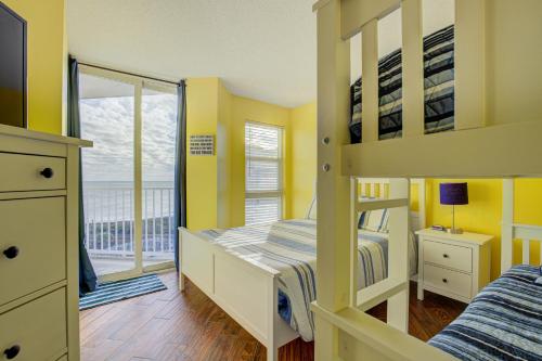 a bedroom with two bunk beds and a balcony at NTBSR3404 St Regis 3404 in North Topsail Beach