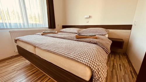 a bedroom with a bed with two pillows at Penzion Ranch in Hořovice