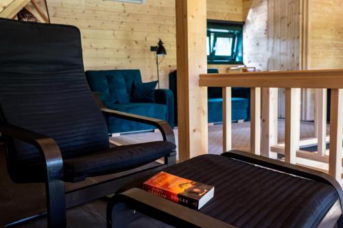 a living room with a chair and a couch at River House Moon in Gospić