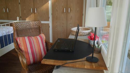a desk with a laptop on a table with a lamp at Glück in Benrath in Düsseldorf