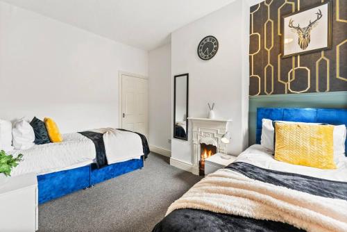 1 dormitorio con 2 camas y chimenea en Sophisticated 2 bed in Doncaster sleeps 6!, en Balby