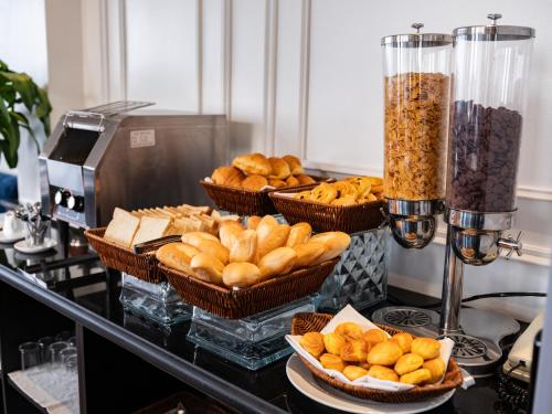 a buffet with baskets of bread and other snacks at The Flower Boutique Hotel & Travel in Hanoi