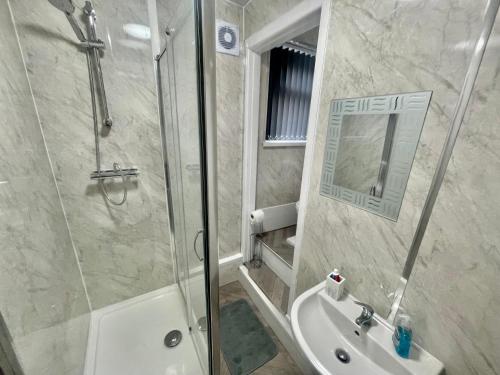 a bathroom with a shower and a toilet and a sink at Empire House in Burnley