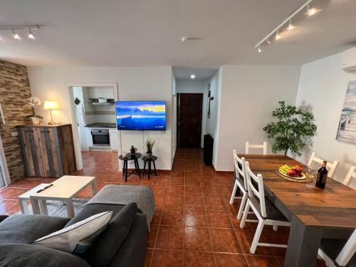 a living room with a couch and a table at Apartman Los Cristianos-Cristimar in Los Cristianos