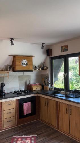a kitchen with wooden cabinets and a stove top oven at Complex A Toplita in Topliţa
