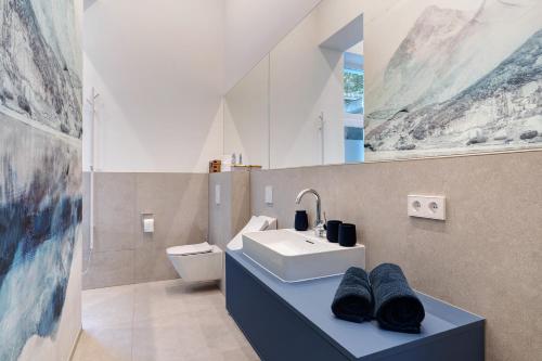 a bathroom with a sink and a toilet at Gästehaus Achern in Achern