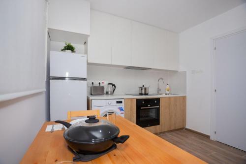 a kitchen with a table with a pan on top of it at STAY Zen Studio in Limassol