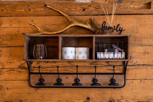 a shelf on a wall with a wooden wall at Ferienhof Greuthof in Bad Wurzach