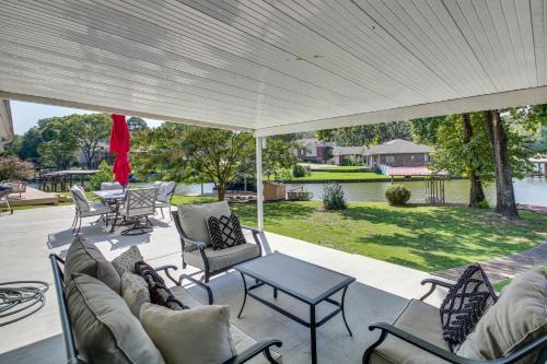 a covered patio with chairs and a table at Waterfront Hot Springs Home with Dock and Porch! in Hot Springs
