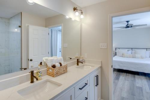 a bathroom with a sink and a mirror and a bed at Waterfront Hot Springs Home with Dock and Porch! in Hot Springs