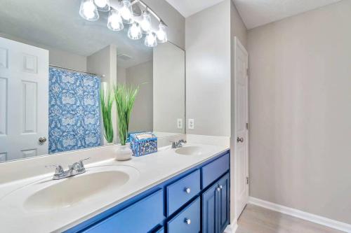 a white bathroom with a sink and a mirror at East Escape in Montgomery