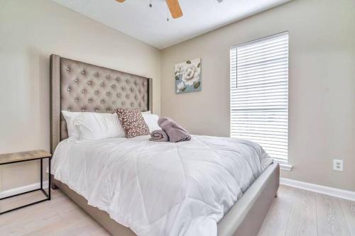 a bedroom with a large bed and a window at East Escape in Montgomery