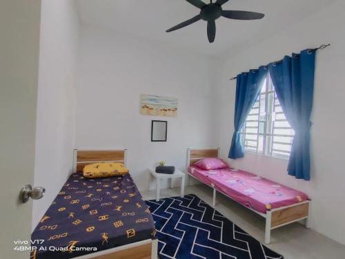 Katil atau katil-katil dalam bilik di Bambom Homestay SP