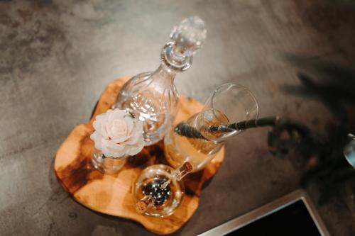 a table with two glasses and a bottle of wine at Wooden Nest in Durbuy