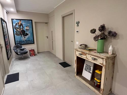 a hallway with a table and a painting on the wall at La Casa all'ombra della Chiesa in Brescello