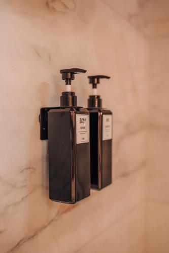 two bottles of soap sitting on a wall at Wooden Nest in Durbuy