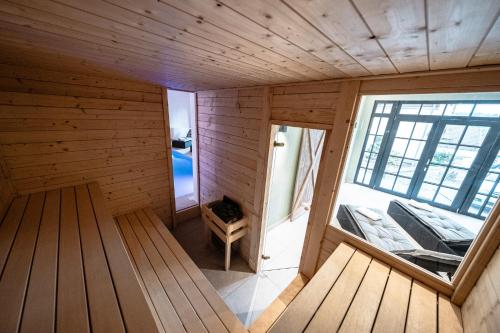 an inside view of a wooden cabin with a window at Eifellodge - am roten Sandberg in Prüm