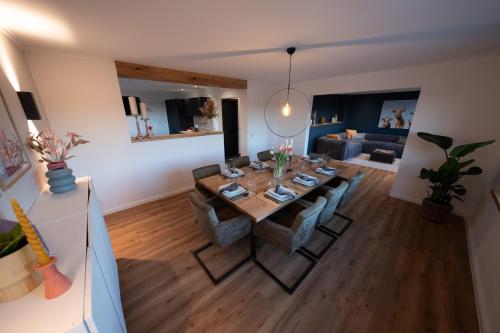 a living room with a table and some chairs at Eifellodge - am roten Sandberg in Prüm